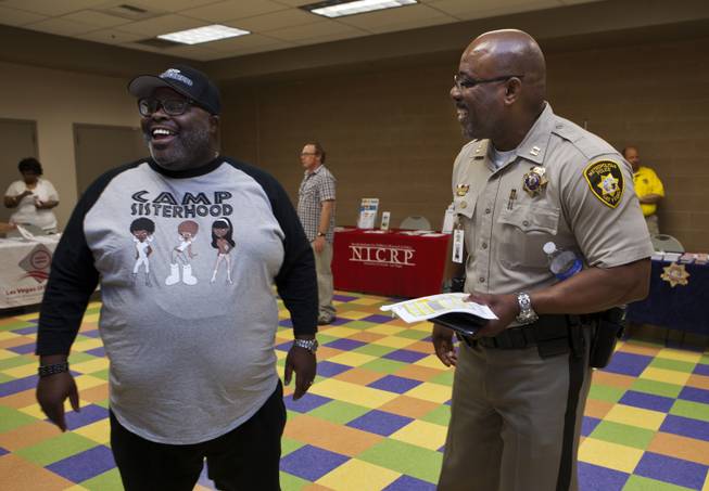 Melvin "Beetle" Ennis jokes with longtime friend Capt. Will Scott of the Bolden Area Command on Saturday, June 28, 2014.  They joined many others at a Stop the Violence event at the Pearson Community Center in response to the recent spate of homicides in that area.