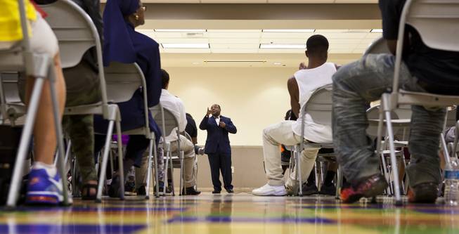 Minister Duke Muhammad relays some words of action to the audience during a "Stop the Violence" event at the Pearson Community Center on Saturday, June 28, 2014.
