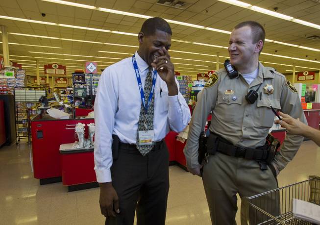 Fred Thomas with Buy Low and Metro Police Officer Gordie Bush share a laugh during a store visit on Thursday, July 3, 2014.  The two are good friends and Thomas is hoping to join the force soon as another way of giving back to his community.