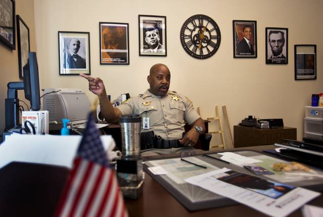 Capt. Will Scott of the Las Vegas Metro Police Department is in charge of the Bolden Area Command, a local neighborhood with some community challenges on Thursday, June 5, 2014.  As inspiration he surrounds himself in his office by a diverse selection of great leaders and thinkers from around the globe.