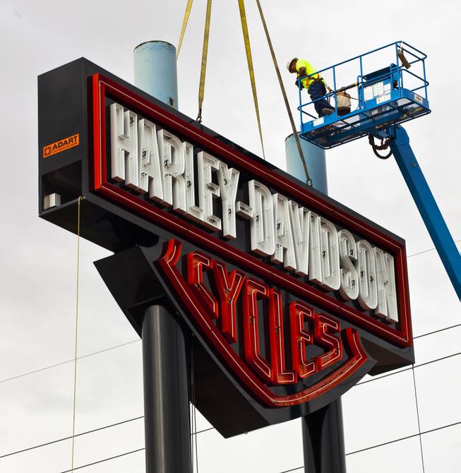 Workers with the Ad Art Sign Company mount the three-piece sign outside the new Las Vegas Harley-Davidson Motorcycle dealership on the South Strip now under construction Thursday, July 10, 2014.