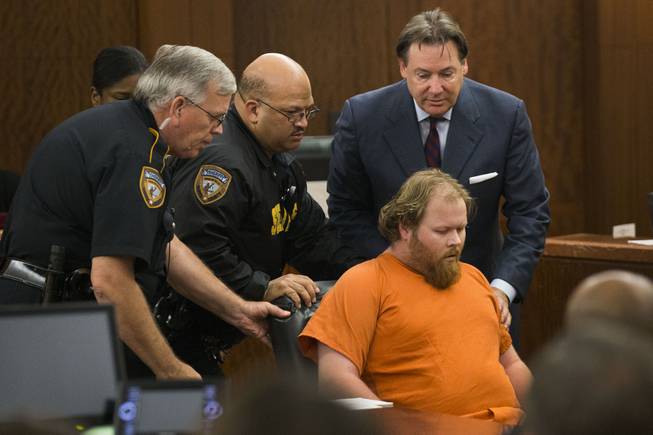 Ronald Lee Haskell collapses as he appears in court on Friday, July 11, 2014, in Houston. Haskell, 33, is accused of killing his ex-wife's sister, Katie Stay, her husband and the children, ranging in age from 4 to 14, after binding and putting them face-down on the floor of their suburban Houston home.