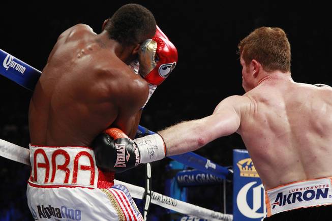 Saul "Canelo" Alvarez hits Erislandy Lara with a body shot during their super welterweight fight Saturday, July 12, 2014 at the MGM Grand Garden Arena. Canelo won a split decision.