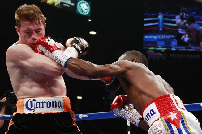 Erislandy Lara hits Saul "Canelo" Alvarez with a left during their super welterweight fight Saturday, July 12, 2014 at the MGM Grand Garden Arena. Canelo won a split decision.