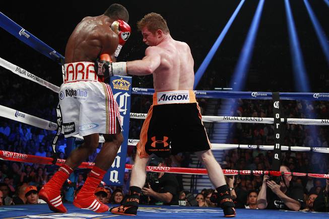 Saul "Canelo" Alvarez hits Erislandy Lara with a body shot during their super welterweight fight Saturday, July 12, 2014 at the MGM Grand Garden Arena. Canelo won a split decision.