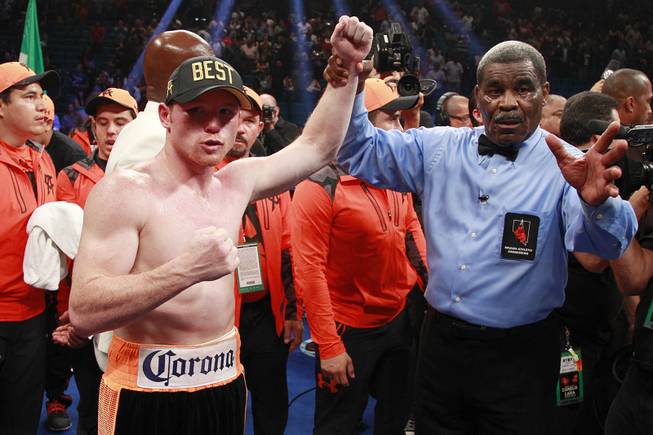 Saul "Canelo" Alvarez, left, celebrates his win over Erislandy Lara following their super welterweight fight Saturday, July 12, 2014 at the MGM Grand Garden Arena.
