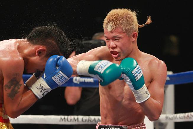 Tomoki Kameda hits Pungluang Singyu with a right during their WBO bantamweight title fight Saturday, July 12, 2014 at the MGM Grand Garden Arena. Kameda won with a 7th round knock out.