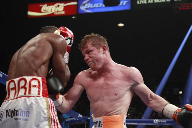 Erislandy Lara, left, fights Saul "Canelo" Alvarez during their super welterweight fight Saturday, July 12, 2014 at the MGM Grand Garden Arena.