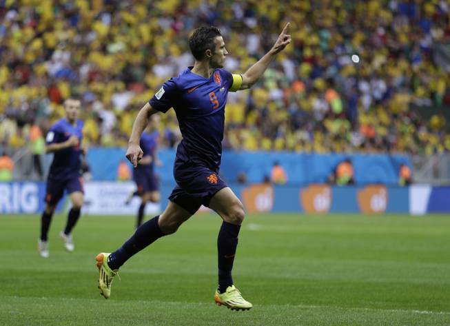 Netherlands' Robin van Persie celebrates after scoring his team's first goal on a penalty shot during the World Cup third-place soccer match between Brazil and the Netherlands at the Estadio Nacional in Brasilia, Brazil, on Saturday, July 12, 2014.