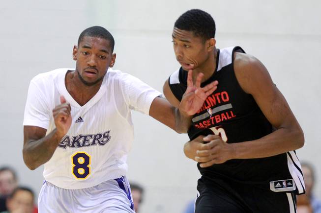 Los Angeles forward Roscoe Smith gets a hand in the face of Toronto forward Bruno Caboclo during their NBA Summer League game Friday, July 11, 2014 at Cox Pavilion.