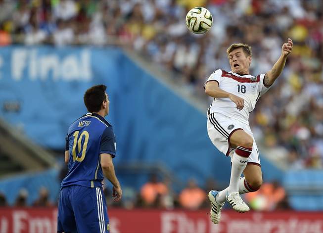 Germany's Toni Kroos (18) rises above Argentina's Lionel Messi (10) to head the ball during the World Cup final soccer match between Germany and Argentina at the Maracana Stadium in Rio de Janeiro, Brazil, Sunday, July 13, 2014.