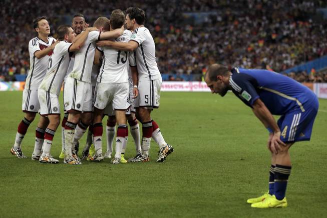 Germany's Mario Gotze (19) celebrates with teammates after scoring his side's first goal in extra time against Argentina's goalkeeper Sergio Romero during the World Cup final soccer match between Germany and Argentina at the Maracana Stadium in Rio de Janeiro, Brazil, Sunday, July 13, 2014.