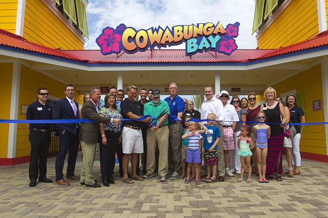 Orluff Opheikens, center, chairman of the board for R&O Construction, politicians and invited guests cut a ribbon during an official opening ceremony for the Cowbunga Bay water park in Henderson Monday, July 14, 2014. The new water park opened on July 4. STEVE MARCUS