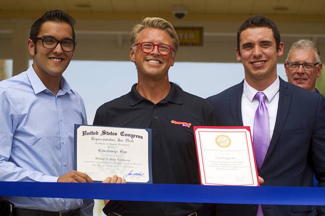 Shane Huish, center, general manager of the Cowbunga Bay water park, poses with Andrew Turcaz, left, representing Congressman Joe Heck, and Stephen Sifuentes, representing Sen. Dean Heller, during an official opening ceremony for the water park in Henderson Monday, July 14, 2014. The park opened on July 4. STEVE MARCUS