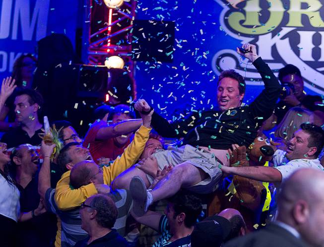 Bruno Politano of Brazil celebrates with supporters after making it to the final table during the World Series of Poker $10,000 buy-in No-limit Texas Hold 'em main event at the RioTuesday morning, July 15, 2014.