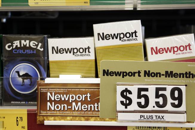 Camel, a Reynolds American brand, and Newport, a Lorillard brand, cigarettes are displayed for sale, Tuesday, July 15, 2014, in Doral, Fla.