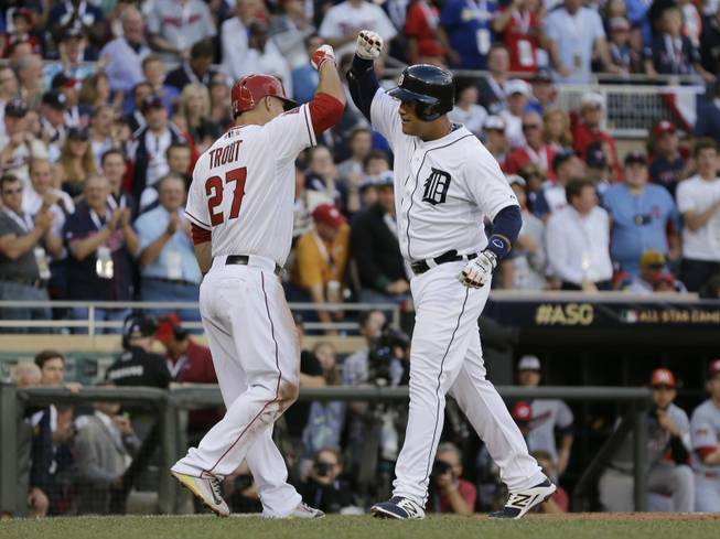 Miguel Cabrera, of the Detroit Tigers, celebrates with Mike Trout, of the Los Angeles Angels, after hitting a home run during the first inning of the MLB All-Star game Tuesday, July 15, 2014, in Minneapolis. 