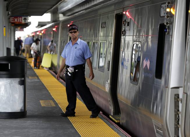A conductor checks the platform at the Jamaica station of the Long Island Rail Road, in the Queens borough of New York, on Wednesday, July 16, 2014. Negotiations aimed at avoiding a walkout at the nation's largest commuter railroad resumed Wednesday after Gov. Andrew Cuomo prodded both sides to find an agreement that would keep 300,000 daily riders from being forced to find alternate ways of getting in and out of New York City.