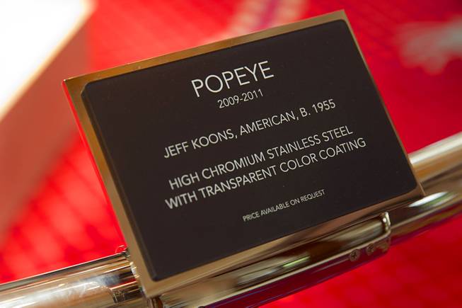 A plaque gives information on the Popeye sculpture in the Wynn Esplanade Thursday, July 17, 2014. The stainless steel sculpture, by American artist Jeff Koons, was purchased at auction for $28.2 million.
