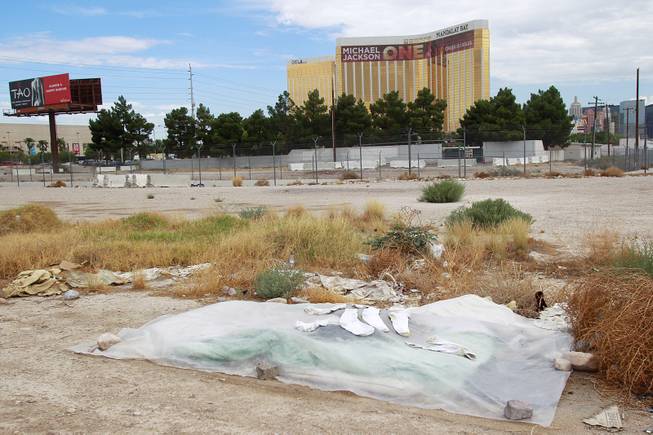The belongings of a homeless person are covered by a tarp on the south end of the Strip Tuesday, July 15, 2014.
