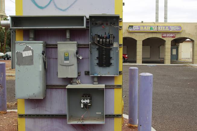 Vandalized electrical boxes are seen on the sign for the shuttered Laughing Jackalope on the south end of the Strip Tuesday, July 15, 2014.