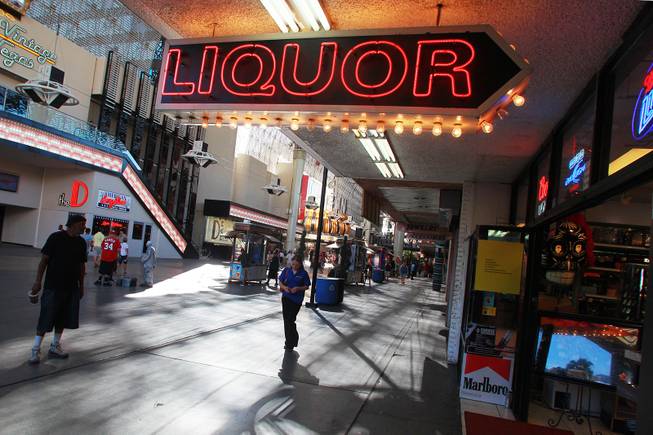 A neon sign advertises liquor for sale at the Fremont Street Experience Thursday, July 17, 2014.