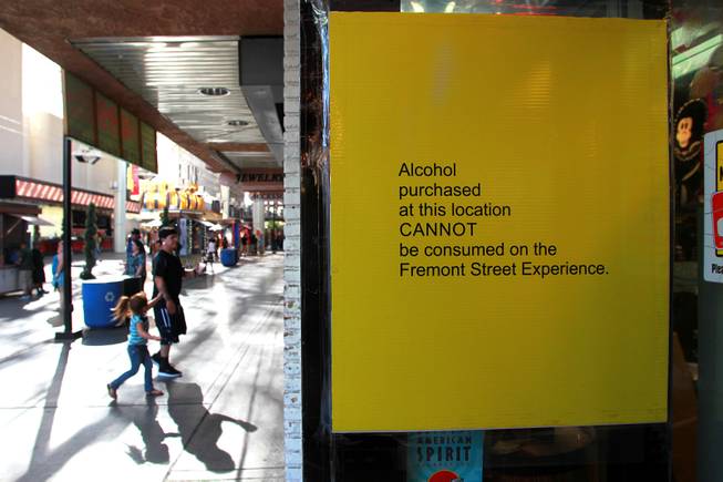 Signage advises that package liquor is not allowed to be consumed at the Fremont Street Experience Thursday, July 17, 2014.