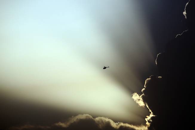 AP10ThingsToSee - A U.S. helicopter flies during clashes between Taliban fighters and Afghan government forces in Kabul, Afghanistan, Thursday, July 17, 2014. Gunmen launched a pre-dawn attack on the Kabul International Airport in the Afghan capital on Thursday. 