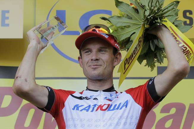 Stage winner Norway's Alexander Kristoff celebrates on the podium of the twelfth stage of the Tour de France cycling race over 185.5 kilometers (115.3 miles) with start in Bourg-en-Bresse and finish in Saint-Etienne, France, Thursday, July 17, 2014. 