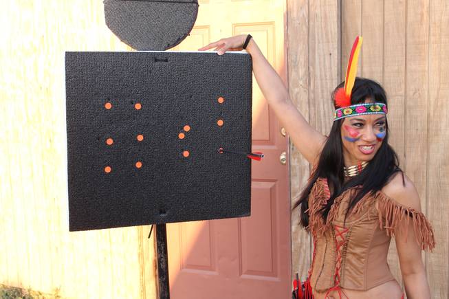 Naomi Gesmundo checks out her archery accuracy during the video shoot for Melody Sweets' "Shoot 'em Up" at Grand Canyon Ranch on April 22, 2014.