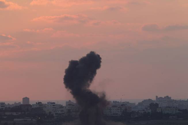 Smoke rises after an Israeli missile strike in the Gaza Strip as seen from the Israel-Gaza border Wednesday, July 16, 2014.