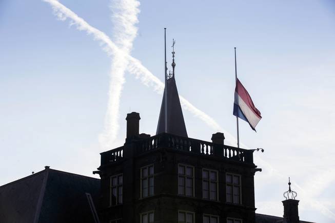 A flag flies half-staff at Binnenhof, the seat of the Dutch government, in The Hague, Netherlands, Friday, July 18, 2014. Flags are flying half-staff across the Netherlands as the country mourns at least 154 of its citizens killed when a Malaysia Airlines passenger jet was shot down in eastern Ukraine.