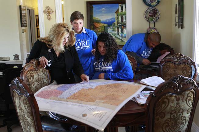 Michelle Fiore meets with volunteers Chance Bonaventura, Felicia Montiel and Irvin Lorenzo in her home May 8, 2014.