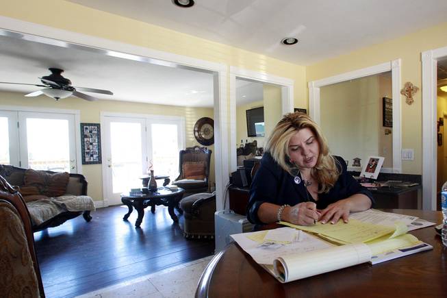 Michelle Fiore makes a phone call from her home May 8, 2014.