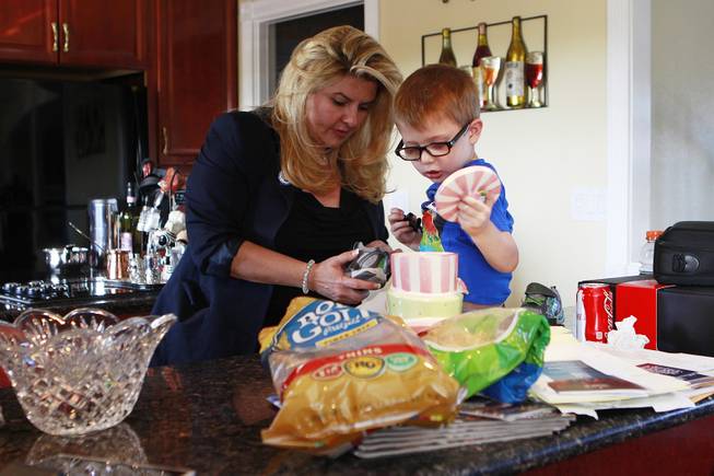 Grandson Jake Willis checks a cookie jar while Michelle Fiore put his shoes on May 8, 2014.
