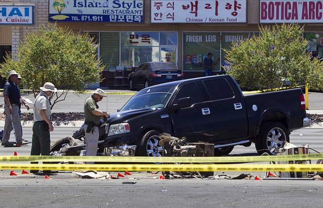 A Metro Police team investigate a fatal accident on Sahara Avenue near Valley View Boulevard Sunday, July 20, 2014. A man who was apparently working on the sidewalk was killed in the accident.