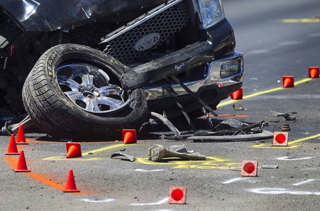 Evidence cones are shown as Metrp Police investigats a fatal accident on Sahara Avenue near Valley View Boulevard Sunday, July 20, 2014. A man who was apparently working on the sidewalk was killed in the accident.