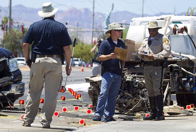 Metro Police confer at a fatal accident on Sahara Avenue near Valley View Boulevard Sunday, July 20, 2014. A man who was apparently working on the sidewalk was killed in the accident.