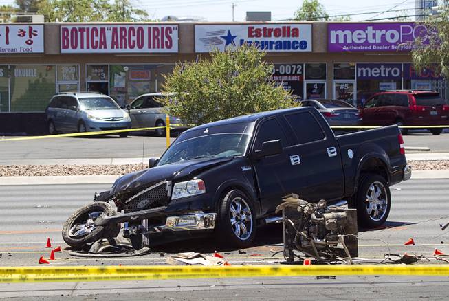 A pickup truck is shown at the scene of a fatal accident on Sahara Avenue near Valley View Boulevard Sunday, July 20, 2014. A man who was apparently working on the sidewalk was killed in the accident.
