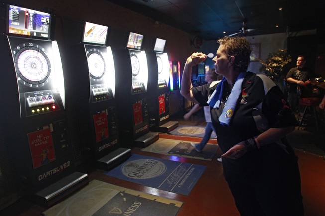 Stacy Bromberg throws during a meeting of the Las Vegas Darts league Wednesday, July 2, 2014 at the Crowbar.
