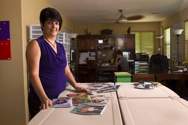 Teazled CEO Dina Proto poses with greeting cards at her office Monday, July 21, 2014. Her wife "Dom" Poist-Proto is at right. Teazled is a company that makes "traditional greeting cards for nontraditional familes."
