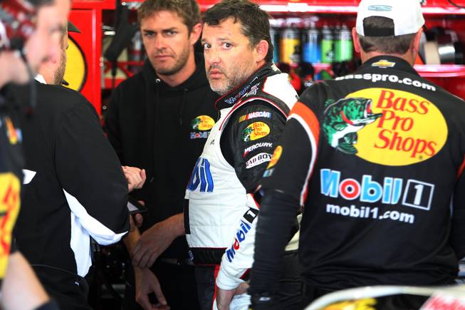 Driver Tony Stewart talks with his crew after practice Saturday, July 12, 2014, for the Sprint Cup Series at New Hampshire Motor Speedway in Loudon, N.H.