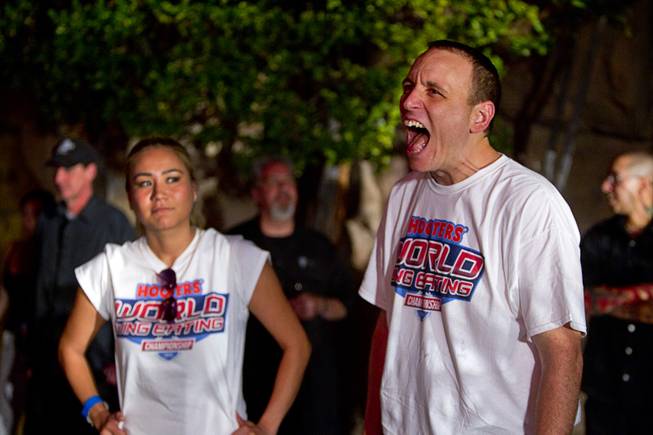 Las Vegan Miki Sudo and Joey Chestnut prepare for competition during the 2014 Hooters "World-Wide Wing Eating Championship" at the Hard Rock pool Tuesday, July 22, 2014.
