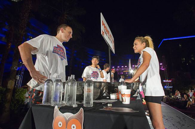 Professional eaters Joey Chestnut and Las Vegan Miki Sudo prepare for competition during the 2014 Hooters "World-Wide Wing Eating Championship" at the Hard Rock pool Tuesday, July 22, 2014.