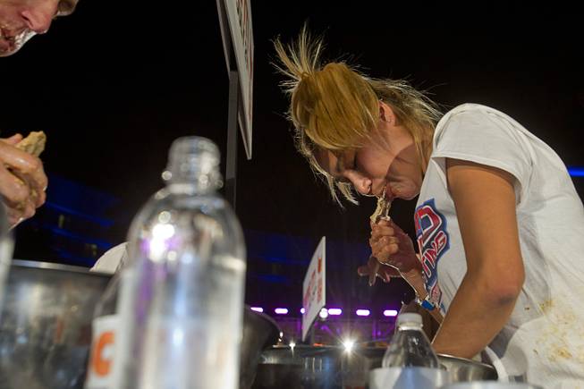 Professional eater Miki Sudo of Las Vegas competes during the 2014 Hooters "World-Wide Wing Eating Championship" at the Hard Rock pool Tuesday, July 22, 2014.