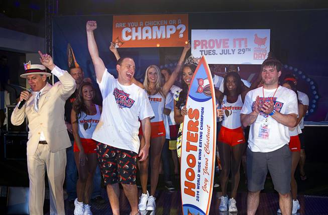 Joey "Jaws" Chestnut celebrates after being declared the winner over second place finisher Adrian "The Rabbit" Morgan, right, during the 2014 Hooters "World-Wide Wing Eating Championship" at the Hard Rock pool Tuesday, July 22, 2014.
