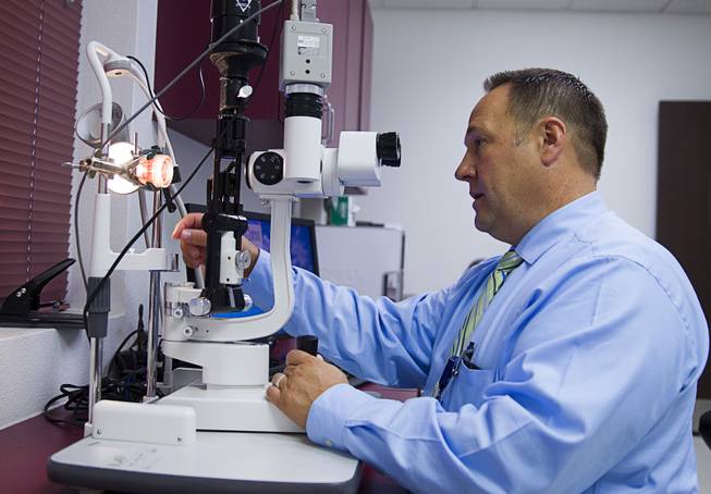 Brent Bergquist, director of ocular services at the Nevada Donor Network, uses slit lamp microscope to check a cornea at the Network offices Tuesday, July 22, 2014.