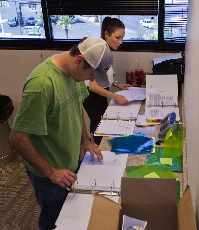 Applicants keep working on their proposals while waiting to be seen on the last day to submit applications to the Las Vegas Department of Planning for medical marijuana dispensaries, cultivation or production on Wednesday, July 23, 2014.