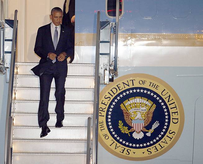 President Barack Obama walks down the stairs of Air Force One upon his arrival at San Francisco International Airport on Tuesday, July 22, 2014.