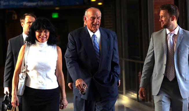Former Minnesota Gov. Jesse Ventura, center, arrives at court with his wife, Terry, and others Tuesday, July 22, 2014, in St. Paul, Minn. 